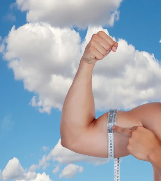 Der muskulöse Arm des Bizeps eines Mannes misst sich selbst — Stockfoto