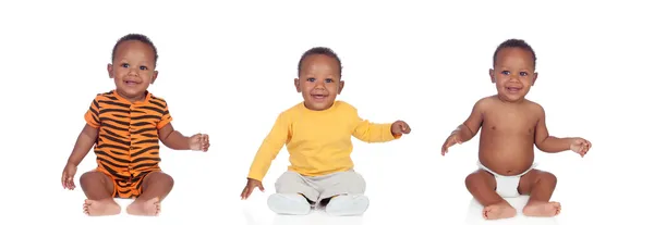 Három egyenlő afrikai babák a különböző ruhák — Stock Fotó