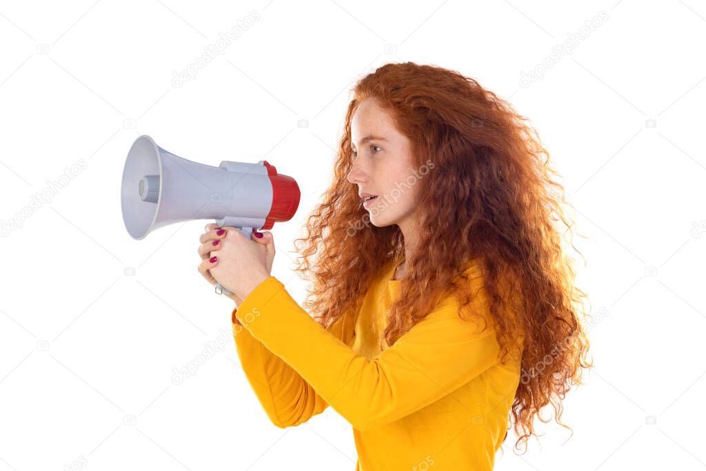 Young redhead woman girl in orange weater posing isolated on white wall background. People lifestyle concept. Scream in megaphone isolated on a white background