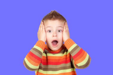 Close up of pretty boy with blond hair screaming loudly, trying to scare friend in school. Copy-space. Studio shot 