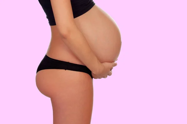 漂亮的怀孕腹部 粉红的背景隔离 — 图库照片