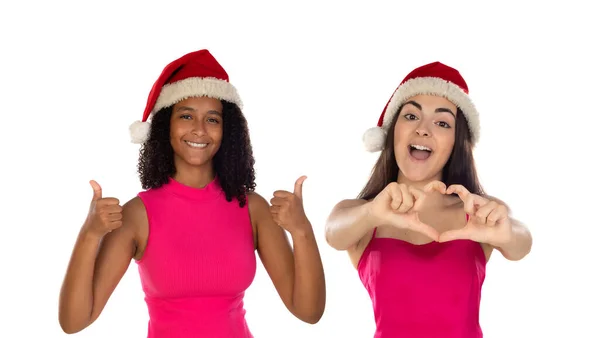 白い背景に隔離されたクリスマスの帽子の十代の女の子の友人 お正月のお祝いのコンセプト 指を上に向けて — ストック写真