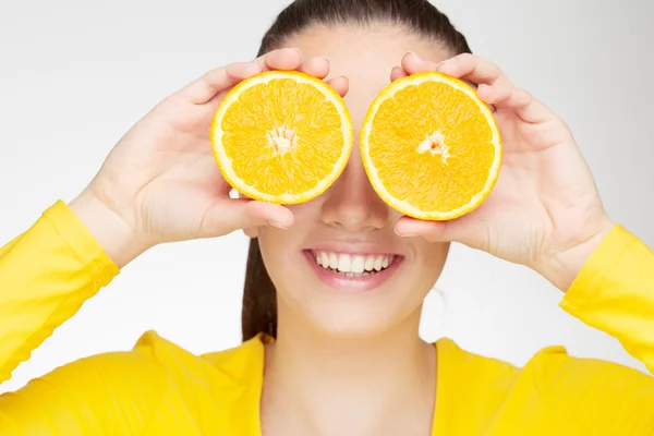 Young brunette with orange in her hand — Stock Photo, Image