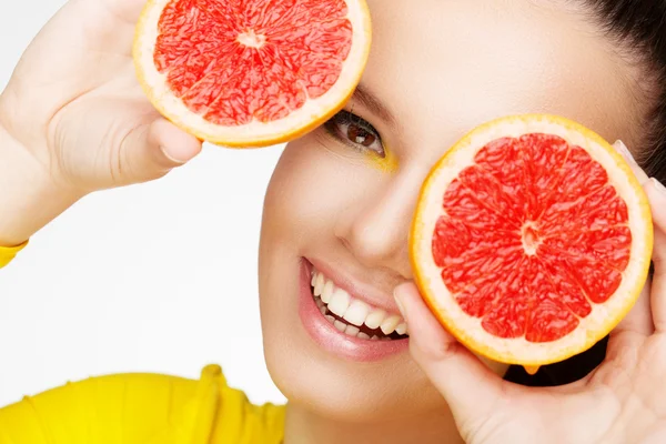 Young brunette with red grapefruit in her hand — Stock Photo, Image