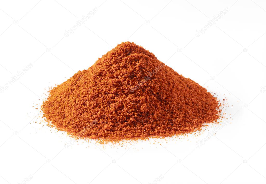 Red pepper powder placed on a white background. Cayenne pepper and paprika powder.