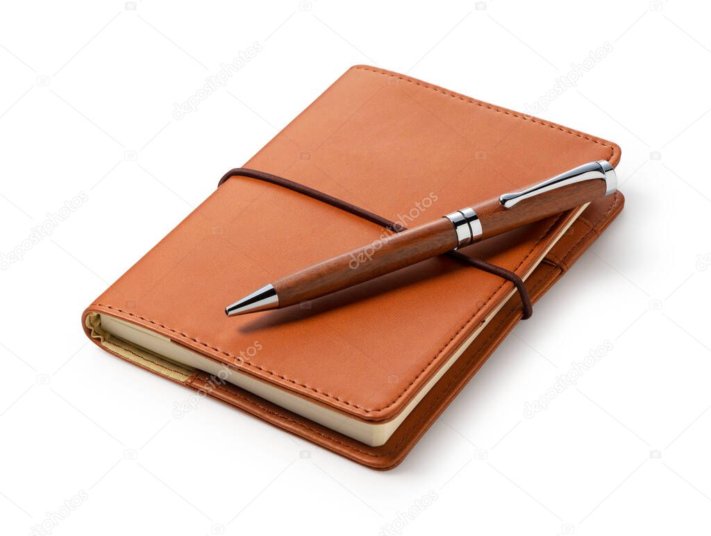 Leather notebook and pen placed against a white background. Business image.
