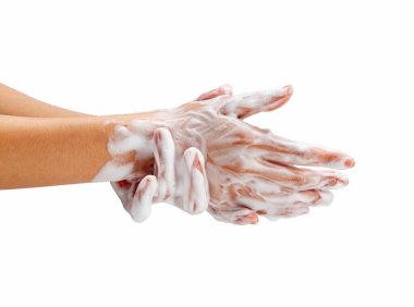 Female hand washing hands with soap lather on white background. Hands with white foam. Texture of white soap foam on female hand.
