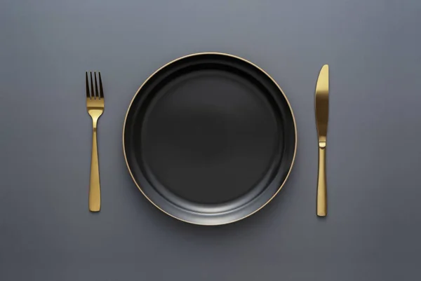 Gold Knives Forks Black Background Empty Black Plate Beautiful Gold — Stock Fotó