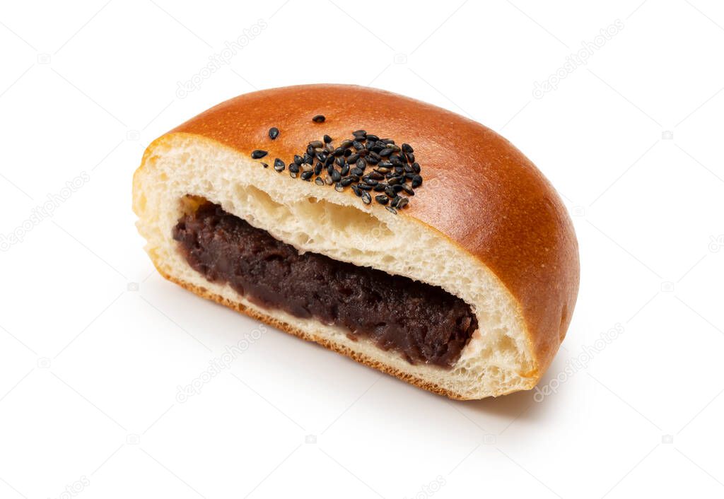 Anpan, cut in half, placed on a white background. Anpan is a Japanese sweet bread.