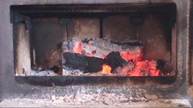 burning firewood in a potbelly stove.flaming fire in a wood-burning stove retro. High quality FullHD footage
