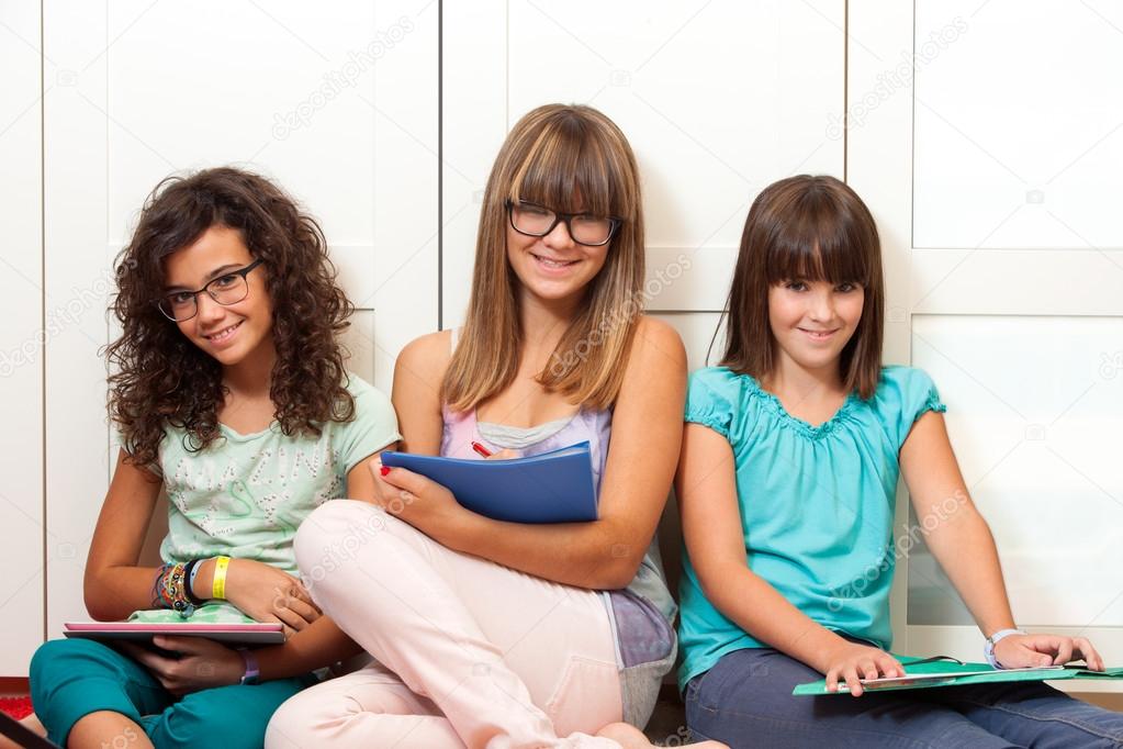 Teenager students sitting with files.