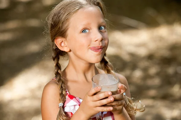 Expressive girl drinking milkshake. — Stock Photo, Image