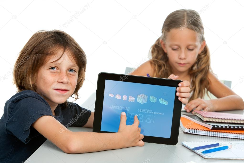 Cute boy student doing maths on digital tablet.