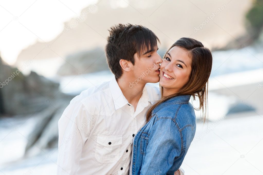 Cute teen couple in love on beach.