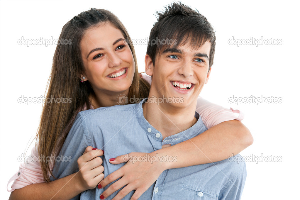 Smiling teen couple isolated.