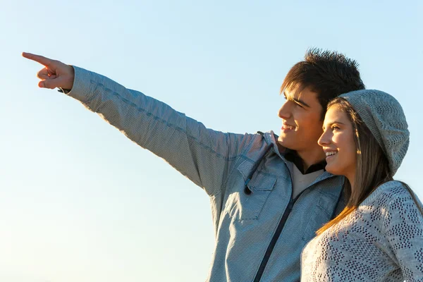 Boy indicating the way to girlfriend. — Stock Photo, Image