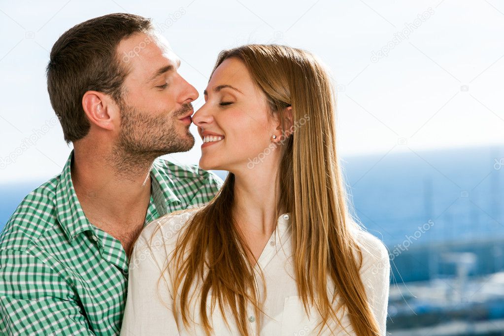 Boyfriend kissing girl on nose.