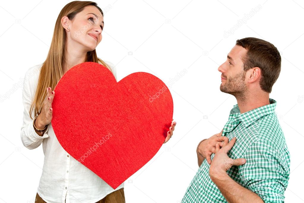 Couple fooling around with heart sign.