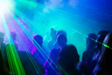 Party dancing under laser light.