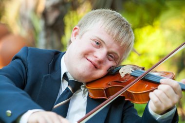 Portrait of young handicapped violinist. clipart