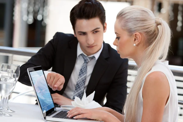 Zakelijke partners werken op laptop bij restaurant. — Stockfoto