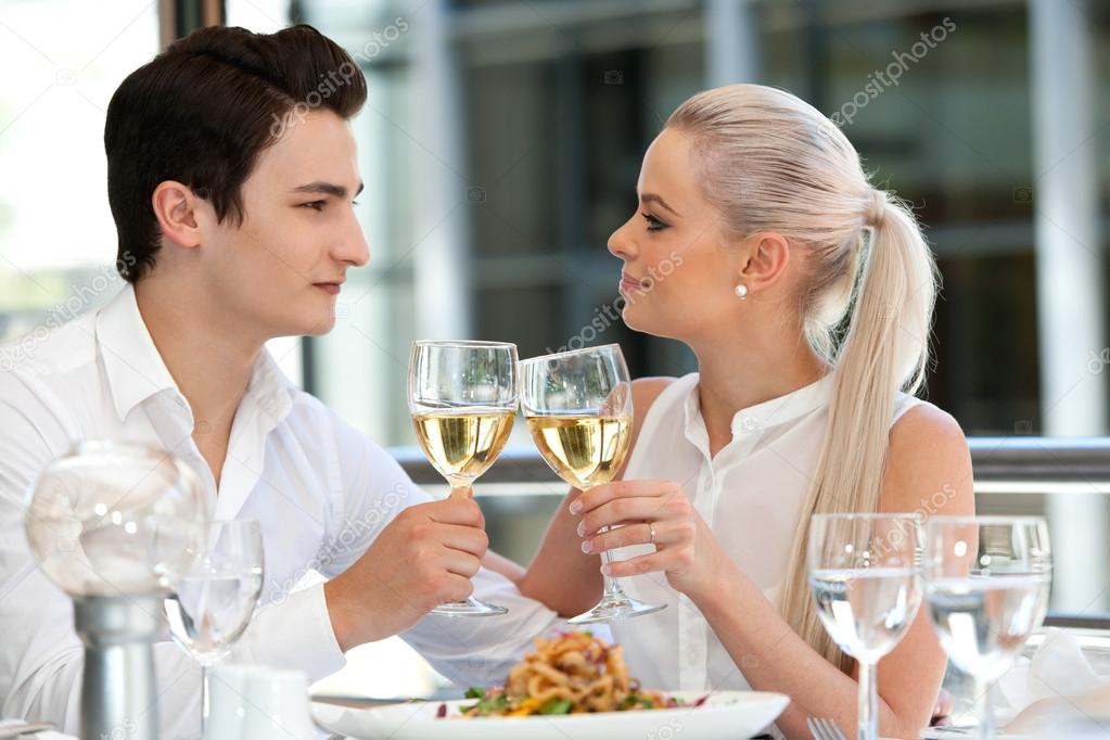 Attractive couple making a toast at dinner.