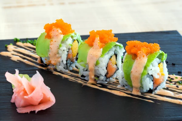 Sake Uramaki with avocado outside. — Stock Photo, Image