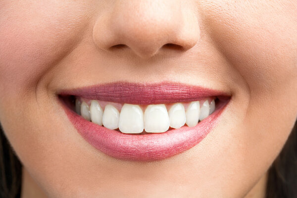 Extreme close up of female smile.