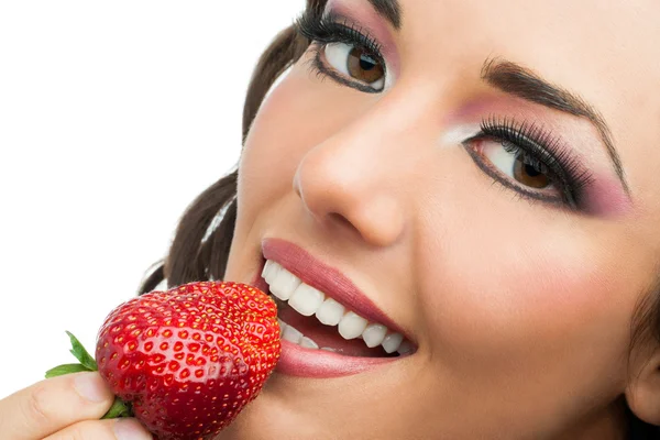 Attractive girl eating strawberry. Stock Picture