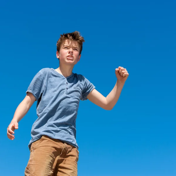 Upset boy raising fist outdoors. — Stock Photo, Image