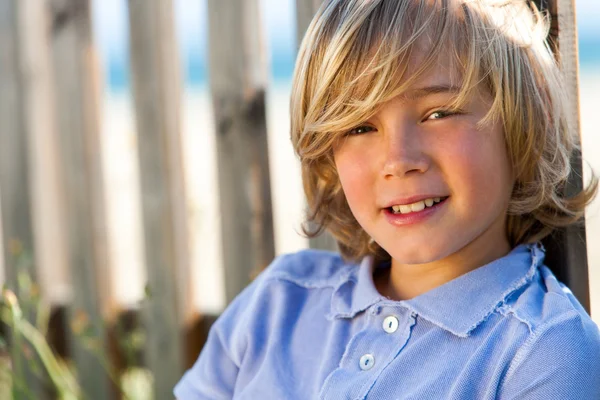 Face shot of handsome boy next to fence. — Stock Photo, Image