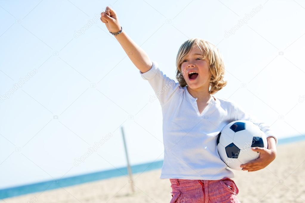 Boy with soccer ball and winning attitude.