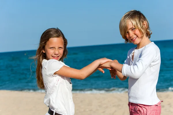 Two friends playing hand game on beach. — Stock Photo, Image