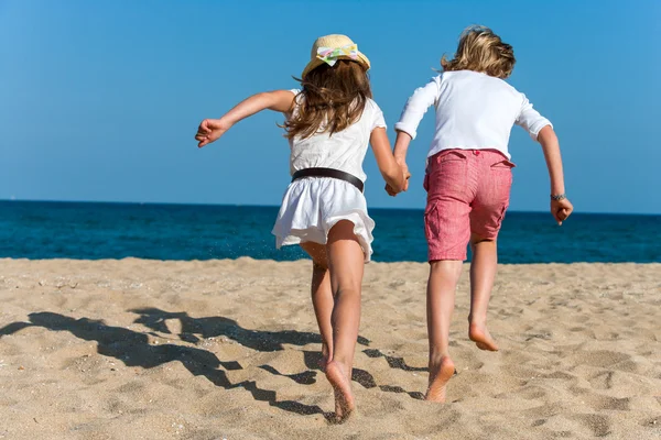 Two kids running together outdoors. — Stock Photo, Image