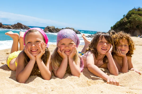Kids laying on the beach. — Stock Photo, Image