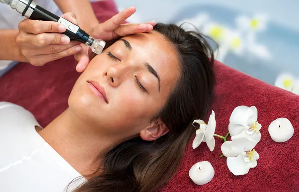 Woman having facial toxin release massage. Stock Photo