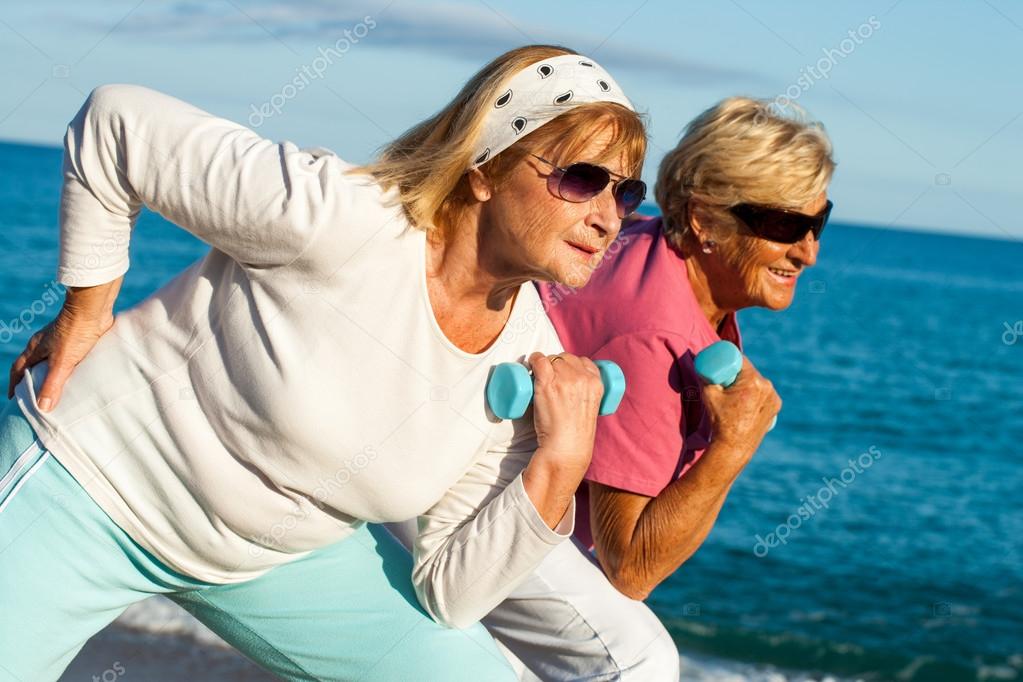 Senior ladies working out on beach.