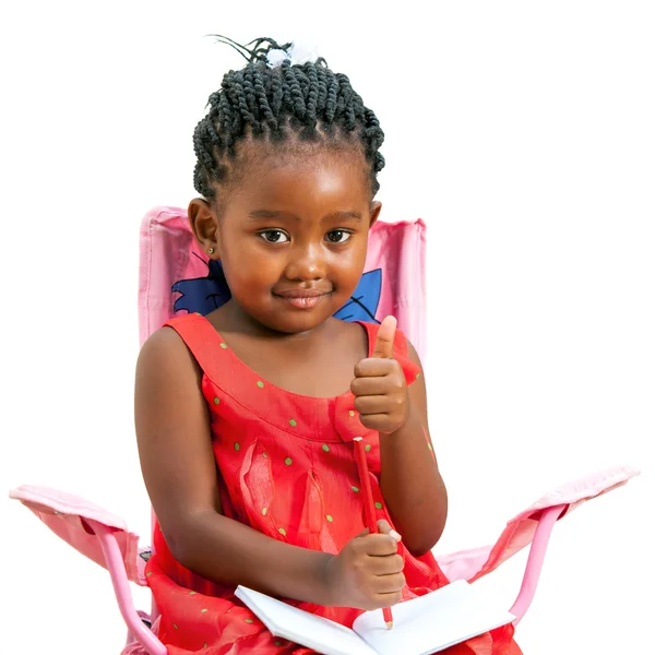 Sweet african kid with note book and thumbs up. — Stock Photo, Image