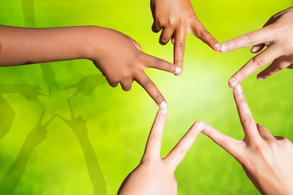 Kids joining fingers forming a star. — Stock Photo, Image