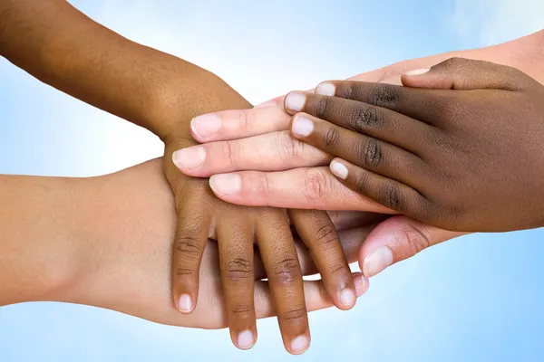 Human races joining hands. — Stock Photo, Image