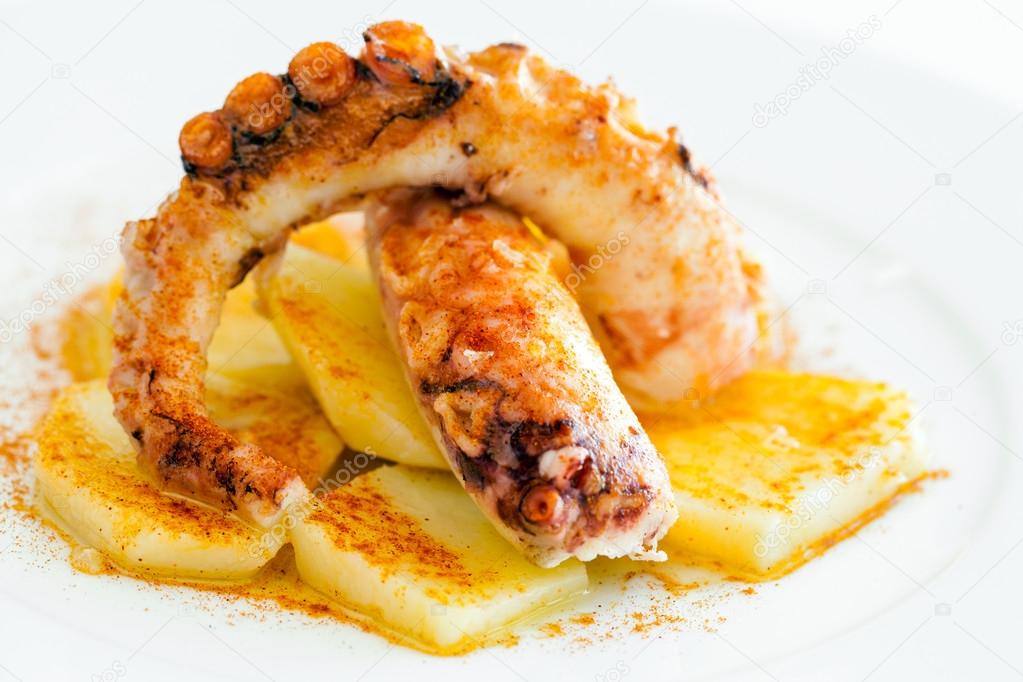 Appetizing octopus with baked potatoes.