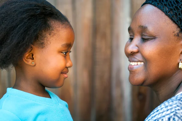 Side view of african mother and daughter. — Stock Photo, Image