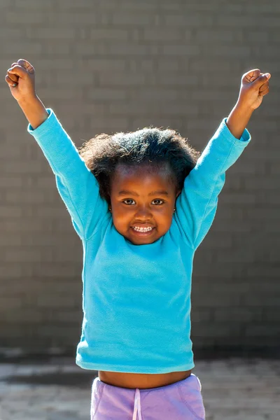 Happy african girl raising arms high. — Stock Photo, Image