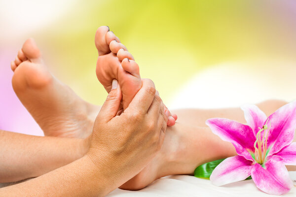 Spa therapist doing foot massage