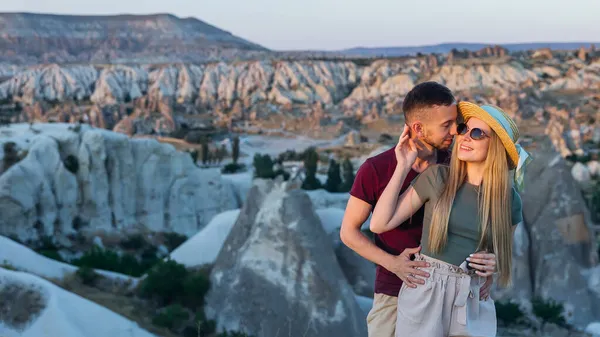 这对恋人在去卡帕多西亚度蜜月的路上恋爱了 他们拥抱着俯瞰群山 — 图库照片