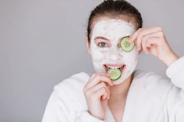 Young Woman Bathrobe Clay Facial Mask Holding Cucumber Slices — Stock Photo, Image