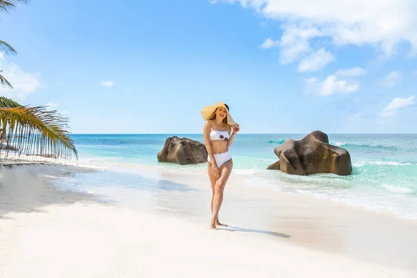 美丽的女人欣赏着塞舌尔拉迪古美丽的海滩 图上完美热带海滩概念的暑假 — 图库照片