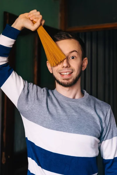 Cheerful Guy Fooling Kitchen While Cooking Holding Wooden Spatula — Photo