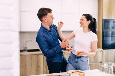 young couple have fun while preparing breakfast in the kitchen.