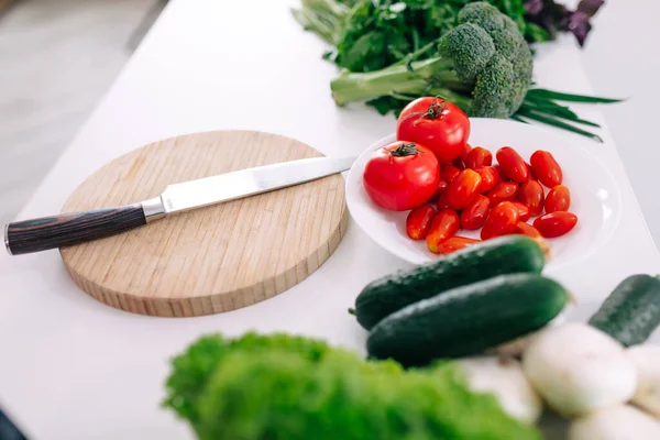 ingredients for cooking vegan dishes, vegetables, roots, spices, mushrooms and herbs. Cutting board, chef's knife, peeler .. Healthy food concept.